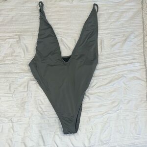 Extremely sexy one piece. Never been worn. Beautiful green color.